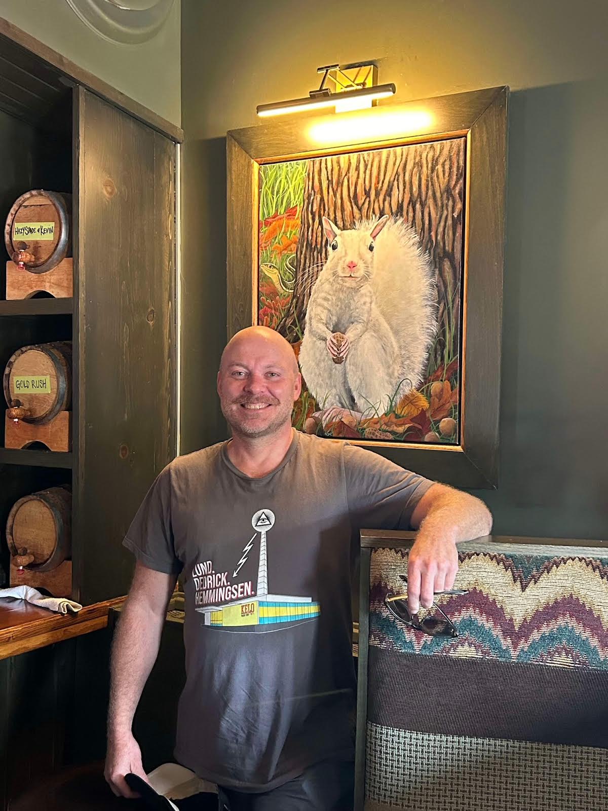 adam overland in front of a painting of a white squirrel